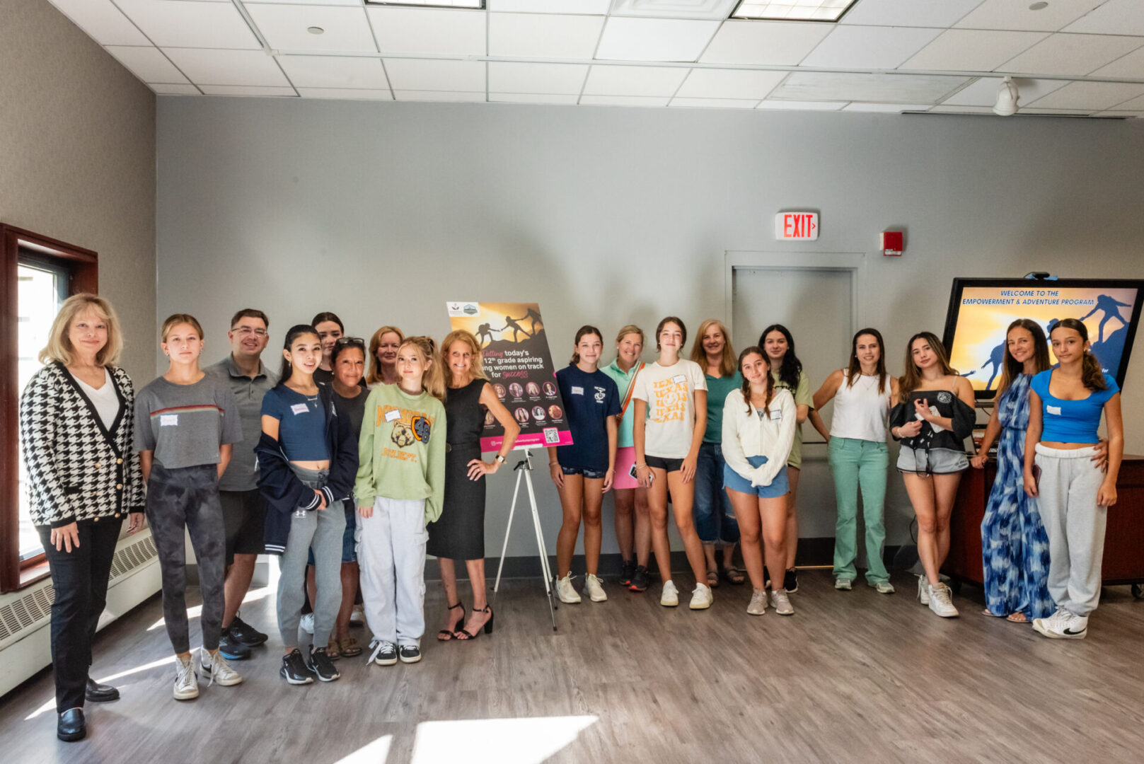 A bunch of kids standing together in a room